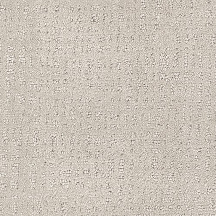 Close-up of Homage Berber Carpet in Abrash—light beige with a soft, textured surface and subtle grid pattern formed by small raised dots and lines. Its woven look is ideal for high-traffic areas.