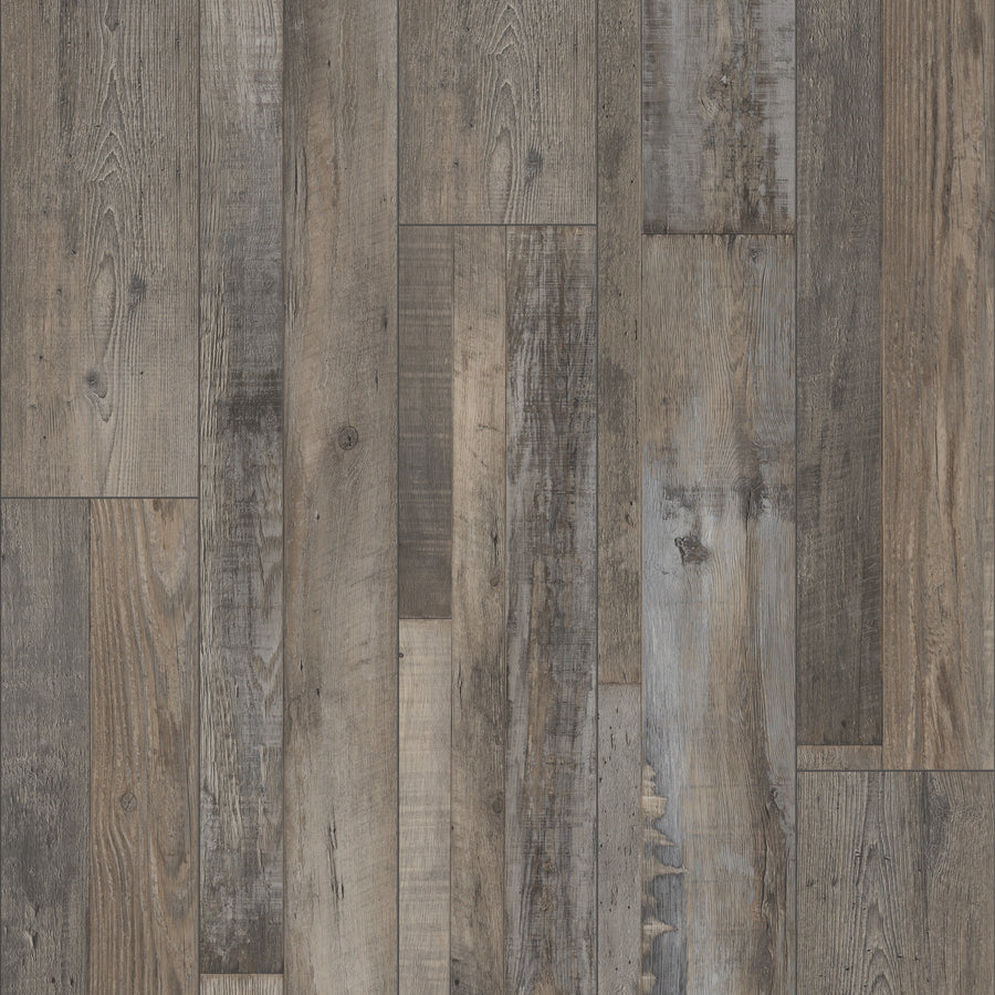 A close-up of Coretec Plus Enhanced Vinyl floorboards shows a blend of brown, grey, and weathered tones with realistic grain and natural textures—ideal for stylish, waterproof flooring.