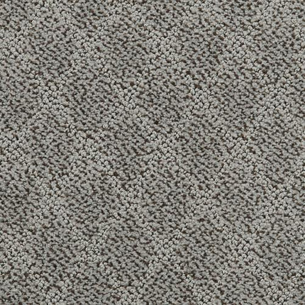 Close-up of Fine Art On Trend Carpet in Adrift shows a soft, dense texture with a repeating diamond pattern. The contemporary design features raised and recessed areas, giving the gray surface an elegant, subtle contrast.