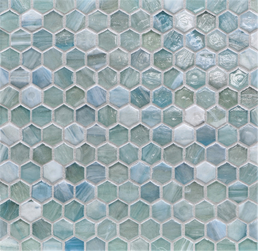 Agate Hexagon Mosaic Glass Tile features hexagonal pieces in blue, green, and white with a glossy finish, creating a textured, shimmering surface with vibrant and dynamic color variations.