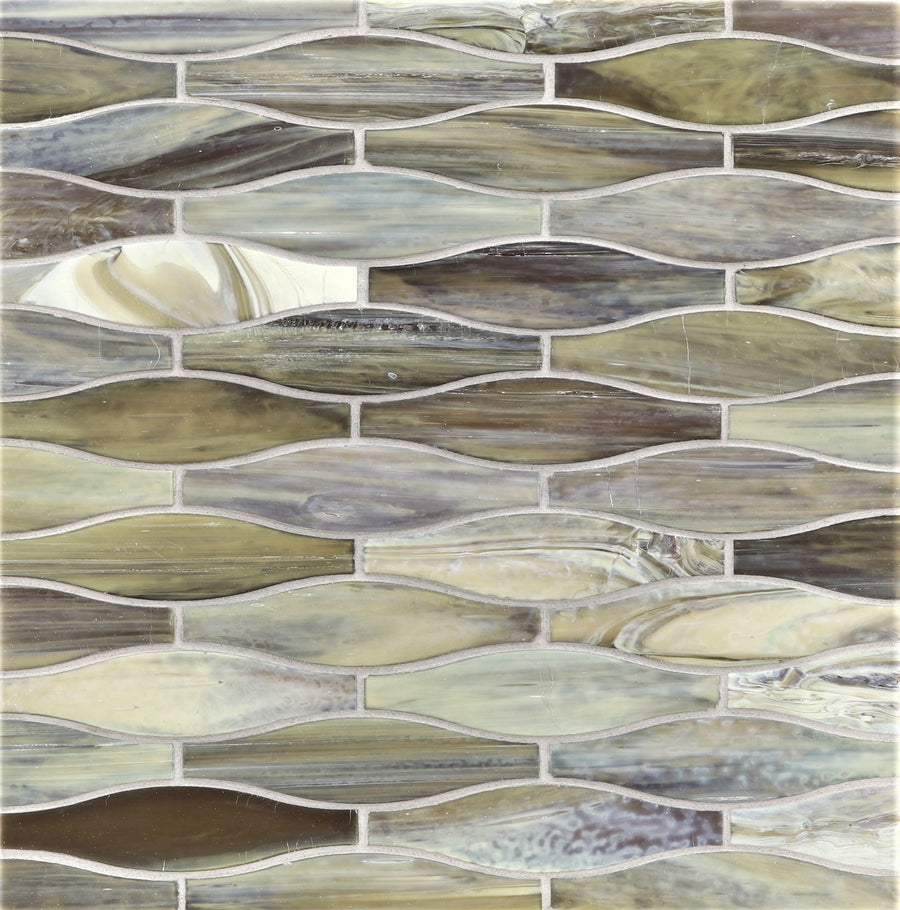 A close-up of the Agate Taiko Mosaic Glass Tile, showcasing elongated, leaf-shaped tiles in earthy tones arranged in a wavy, interlocking pattern with a three-dimensional mosaic effect.