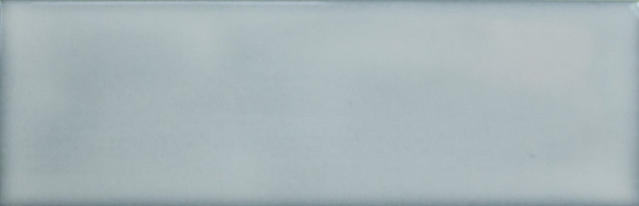 The Alchemist 2" x 6" Subway Tile in Pool features a light blue-gray hue, smooth glossy finish, and slightly rounded edges—ideal for accent walls or kitchen backsplashes.