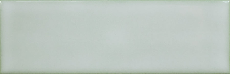 The Alchemist 2" x 6" Subway Tile in Sage features a rectangular, glossy finish with smooth edges and a subtle gradient near the top—ideal for kitchen backsplashes or accent walls.