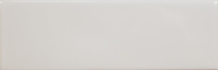 The Alchemist 2" x 6" Subway Tile in Silk is a glossy white ceramic tile with smooth edges and a plain surface, ideal for accent walls or kitchen backsplashes.