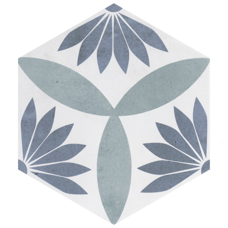 The Amelia Blue 7" Hexagon Ceramic Tile in Palm Royale Blue features a white background with three blue-gray petal clusters and light green leaf shapes radiating from the center for a bold geometric floral look.