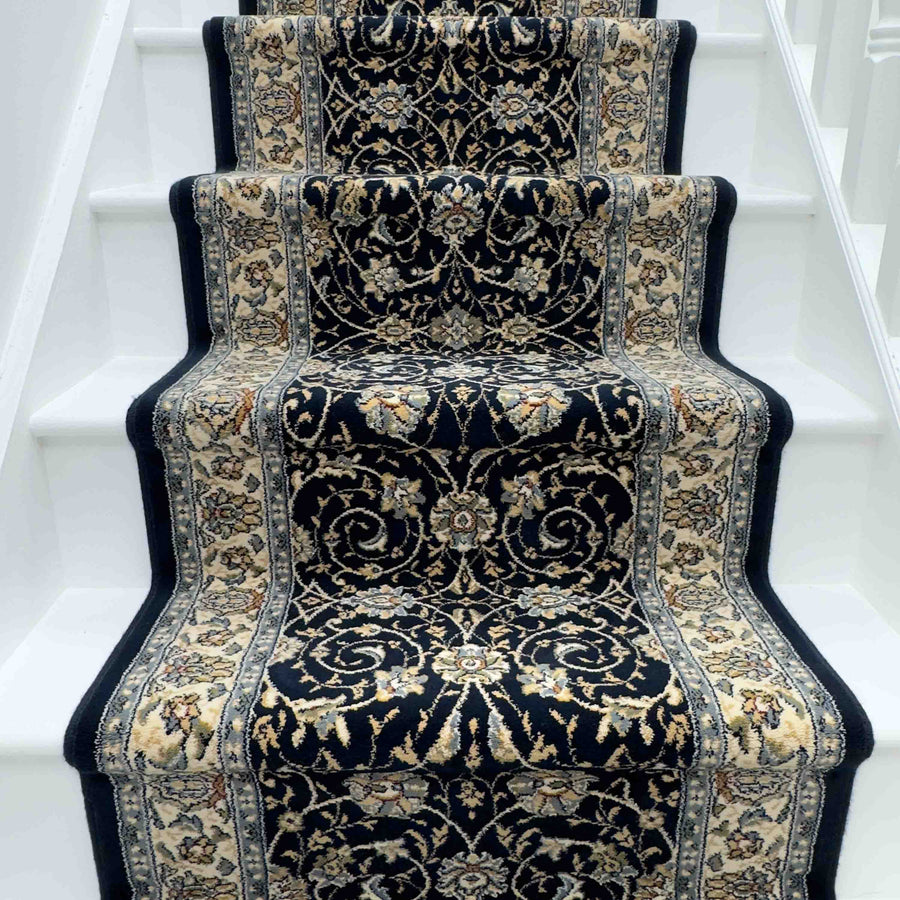A white staircase with the Ancient Garden 57120-1464 Runner Rug in dark blue and beige, showcasing Persian-inspired floral and vine patterns—an elegant choice for a hallway or entryway rug.