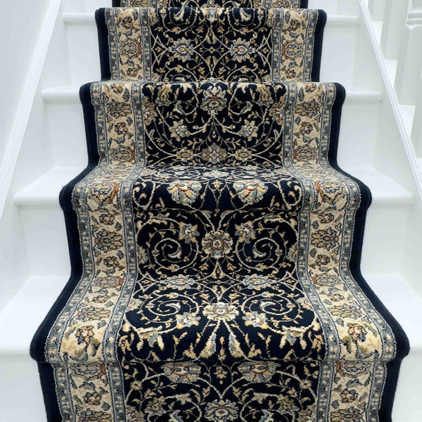 A white staircase with the Ancient Garden 57120-1464 Runner Rug in dark blue and beige, showcasing Persian-inspired floral and vine patterns—an elegant choice for a hallway or entryway rug.