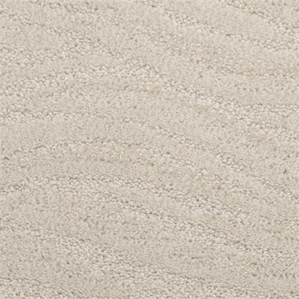Close-up of Taittinger On Trend Carpet in Annapolis—a light beige, textured luxury flooring with a subtle wavy pattern from its soft, raised pile. Ideal for high-traffic areas and stylish interiors.