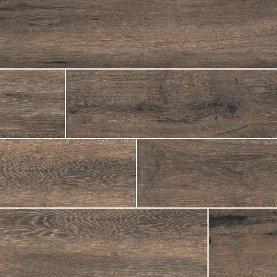 The Antonius 6x36 Porcelain Tile features a wood grain texture in brown and gray tones, perfect for staggered patterns. Add natural, rustic style and warmth to any space with these durable, wood-look porcelain tiles.