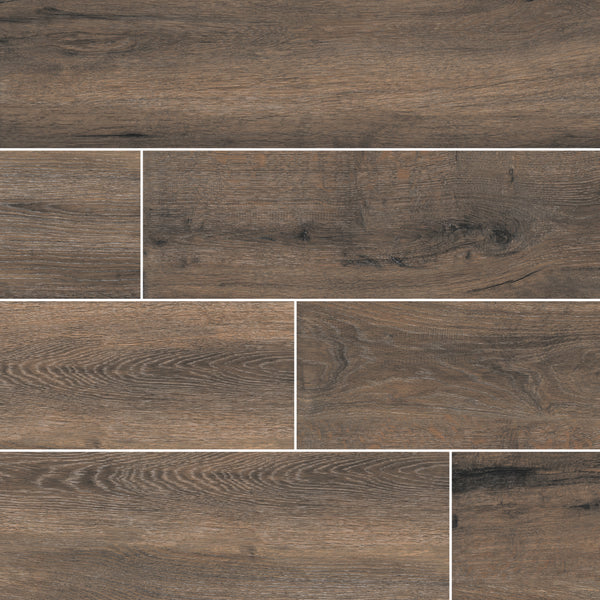 The Antonius 6x36 Porcelain Tile features a wood grain texture in brown and gray tones, perfect for staggered patterns. Add natural, rustic style and warmth to any space with these durable, wood-look porcelain tiles.