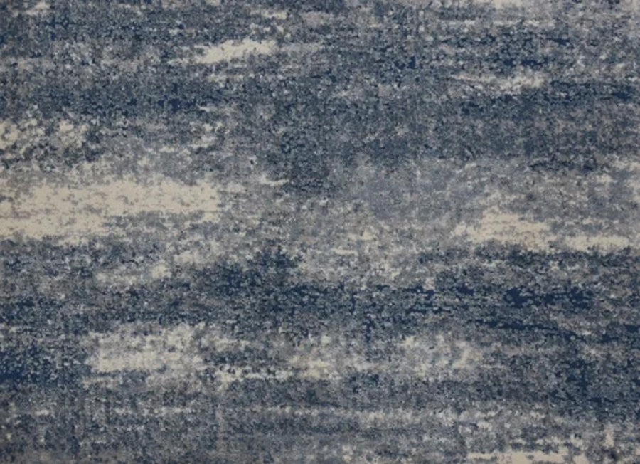 Rock And Roll On Trend Carpet in Arctic features an abstract textured surface with irregular blue, gray, and off-white streaks—evoking a cloudy sky. Stylish and durable, it's ideal for high-traffic areas.