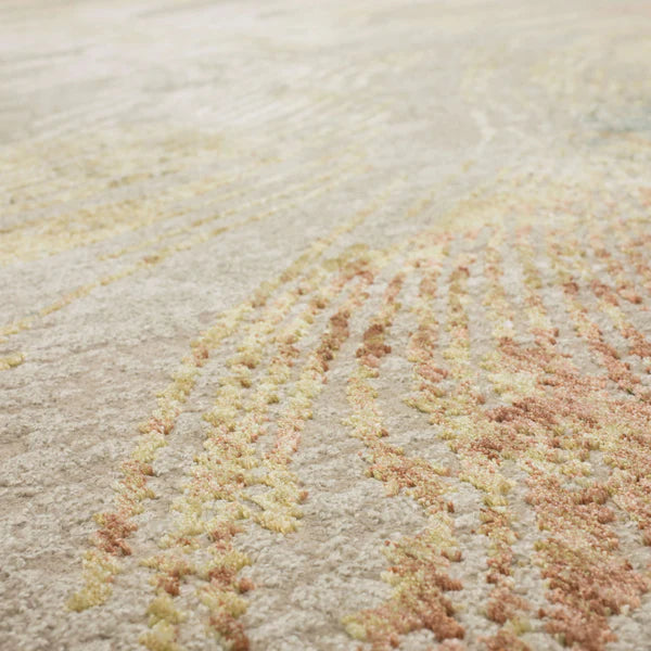 Close-up of a textured carpet with a soft, abstract pattern in shades of beige, yellow, and light pink, featuring raised, tufted details and a plush surface.
