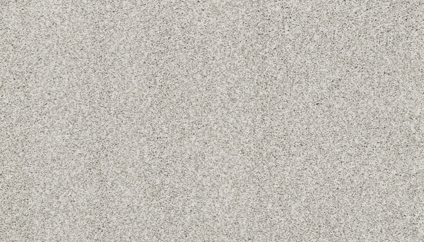 Close-up of fine, light-colored sand with beige and gray tones inspires the Artisan Elements Family Friendly Carpet in Stepping—a soft, uniform surface ideal for high-traffic family spaces.