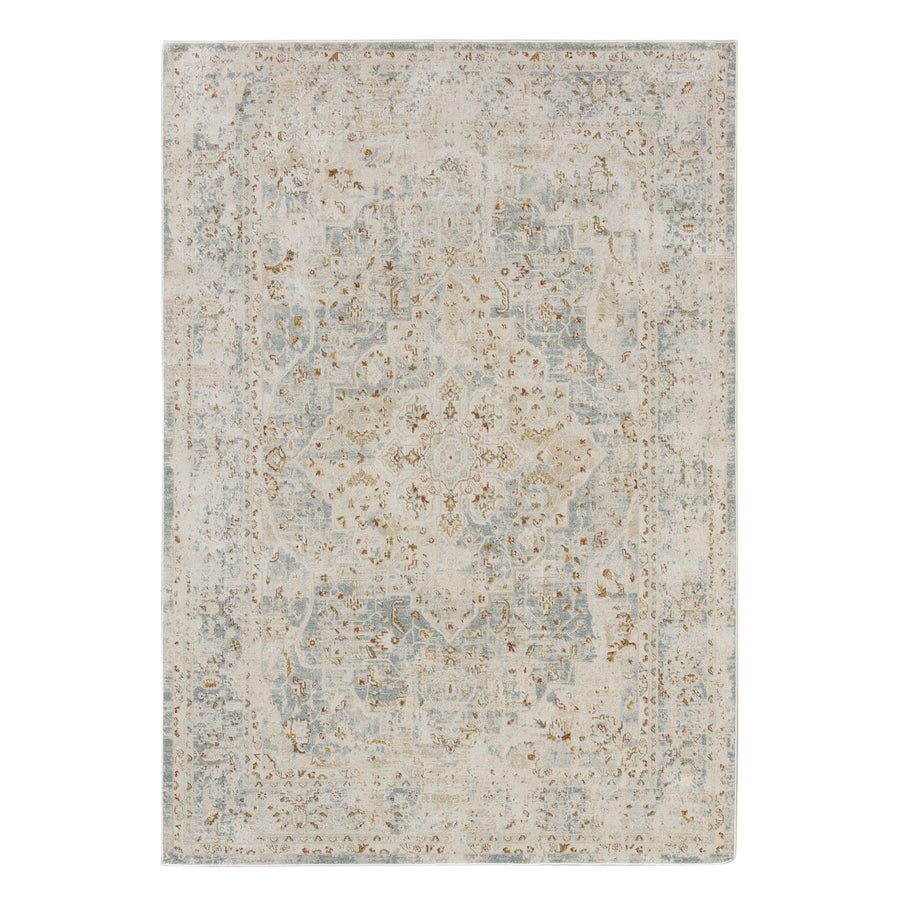 The Windermere Ashbourne Blue Area Rug features an ornate, traditional pattern with a central medallion and intricate border in muted beige, light blue, and brown tones.
