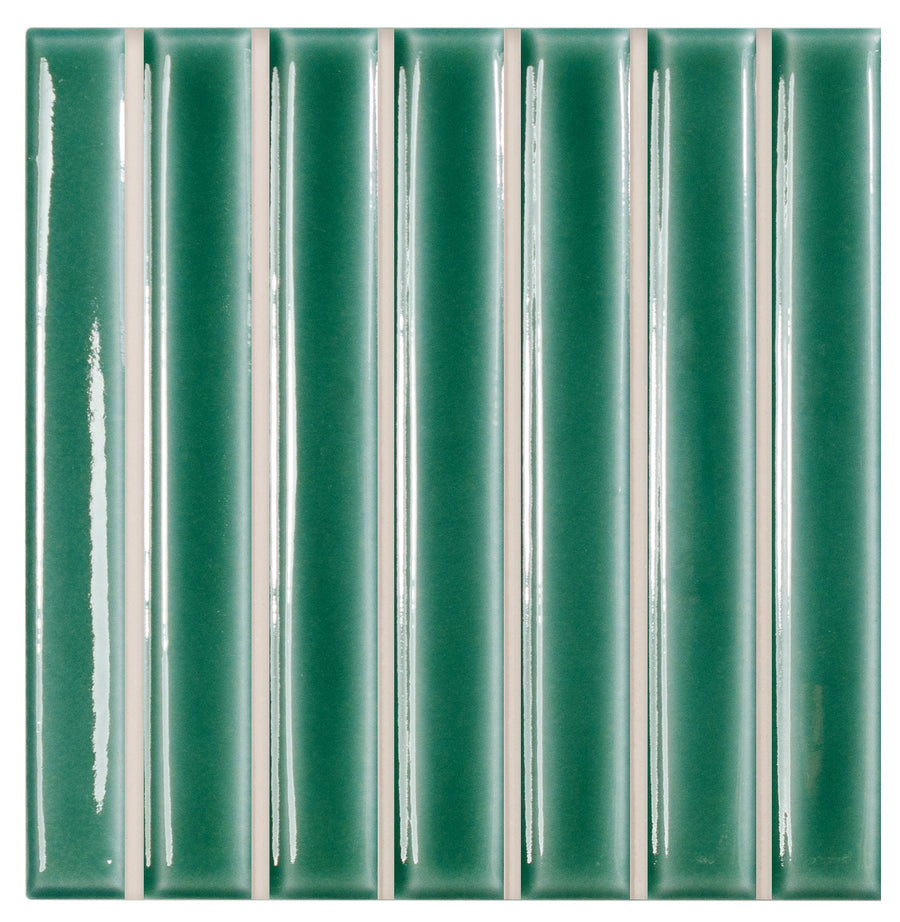 The Astria 4.6" x 4.6" Deco Ceramic Tile in Turquoise Glossy features a square layout with thin white grout lines—perfect for backsplashes or accent walls, creating a clean, symmetrical pattern.