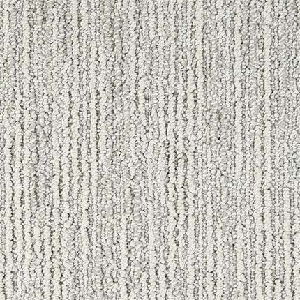 Close-up of Advocate Berber Carpet in Award Winner color, featuring a textured, looped pile with subtle vertical stripes. The durable surface appears soft and slightly raised.