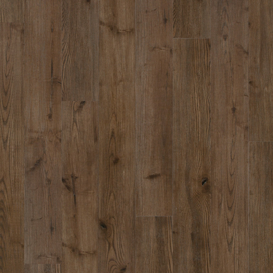 Coretec Originals Classics Vinyl features medium brown planks with visible grain and natural knots. Its matte finish and realistic wood look, paired with a rigid core, deliver rustic style and durable performance.