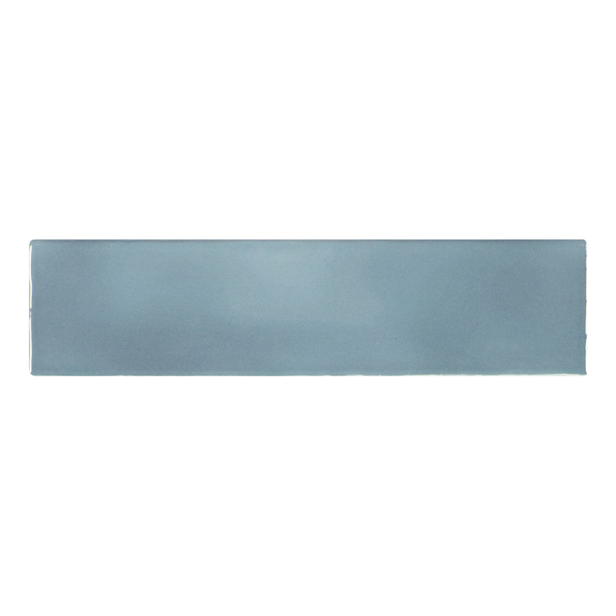 The Brooklyn 3" x 12" Ceramic Subway Tile in Denim features a rectangular, glossy finish with smooth edges and a subtle gradient—ideal for bathroom walls or kitchen backsplashes.