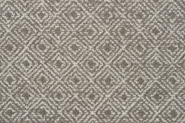 Close-up of Brentwood Berber Carpet in Flannel, showcasing its textured fabric with a repeating diamond pattern in gray and white for a sophisticated, geometric, and symmetrical look.