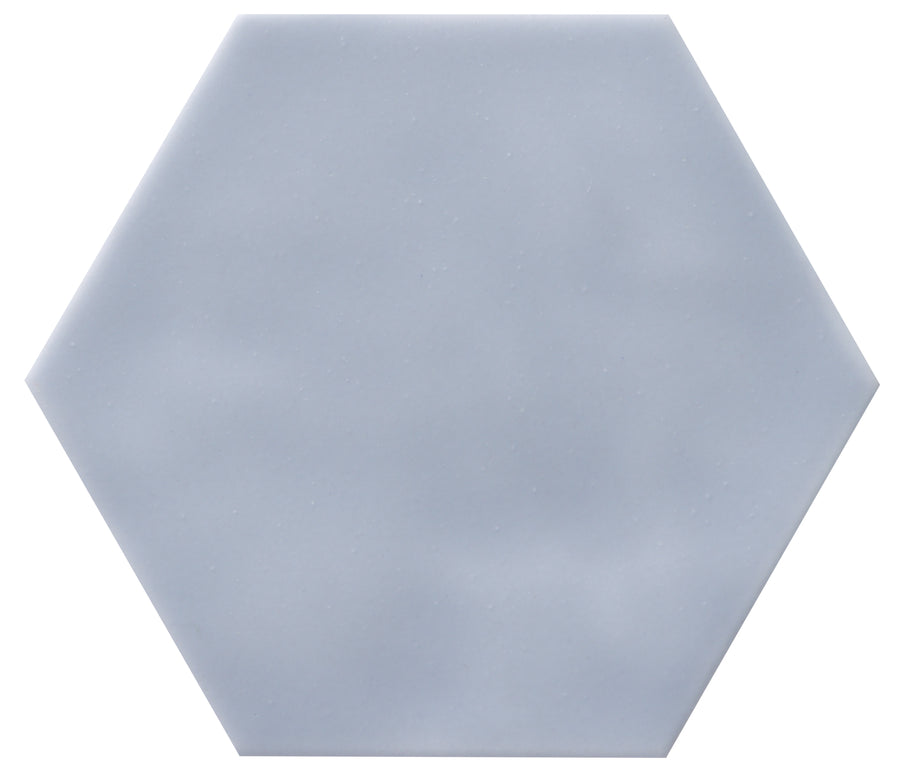 The Zephyr 4.2x4.9 Hexagon Ceramic Tile is a light gray, hexagonal ceramic tile with a smooth matte finish, displayed on a white background. Special-order item.