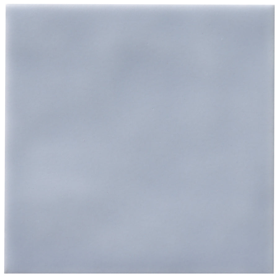 The Zephyr 4x4 Ceramic Tile is a smooth, plain, square tile in a light grayish-blue shade with soft, even shading and no pattern, ideal for a subtle Mediterranean style. Available by special order.
