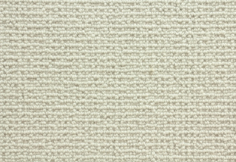 Close-up of Sequoia Berber Carpet in Barley, showcasing a textured, light beige surface with a repeating linear pattern made from tightly woven, premium fibers—ideal for durable flooring in high-traffic areas.