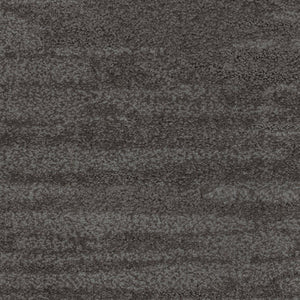 A close-up of Cirrus Berber Carpet in Basalt color, featuring a soft, plush surface with dark gray tones and subtle horizontal pattern variations for a luxurious feel.