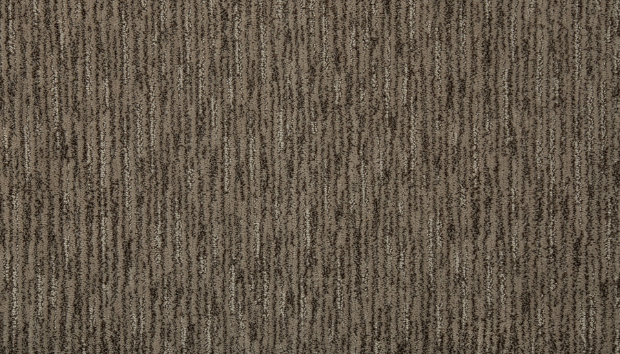 Close-up view of Beautiful Elements Pet Friendly Carpet in Malted, featuring a textured brown surface with subtle vertical stripes in various shades of brown and beige, blending softness and durability for a luxurious look.