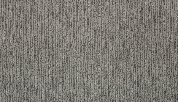 Close-up of Beautiful Elements Pet Friendly Carpet in Bliss, showcasing a textured, vertical striped pattern with shades of gray and black. This luxury carpet is soft, pet-friendly, and features a subtle modern design.