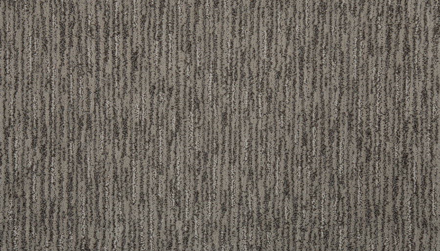 Close-up of Beautiful Elements Pet Friendly Carpet in Shale, featuring a textured gray surface with vertical dark and light stripes for a subtly luxurious look.
