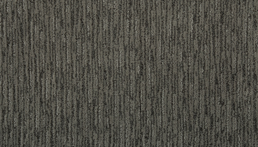 Close-up of Beautiful Elements Pet Friendly Carpet in Stone—a textured gray with vertical, slightly irregular lines in light and dark shades for a subtle striped look. Stylish and durable, it's designed to be pet friendly.
