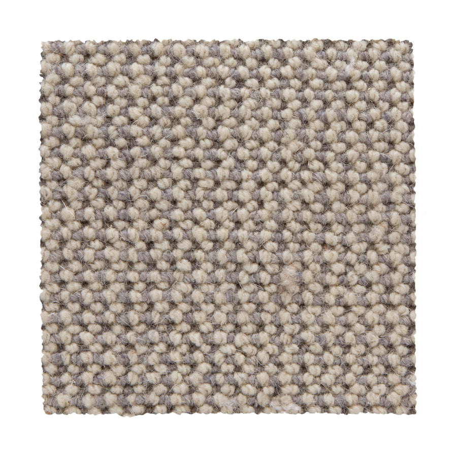 A square swatch of Bellarine Berber Carpet in Alabaster, featuring textured loop-pile fibers for a uniform, speckled look. Displayed on a white background, its tightly woven construction ensures durable performance.