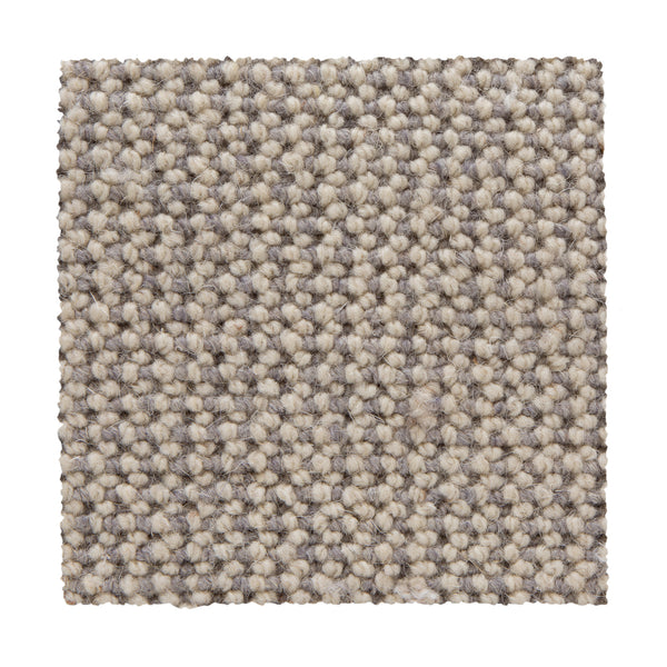 A square swatch of Bellarine Berber Carpet in Alabaster, featuring textured loop-pile fibers for a uniform, speckled look. Displayed on a white background, its tightly woven construction ensures durable performance.