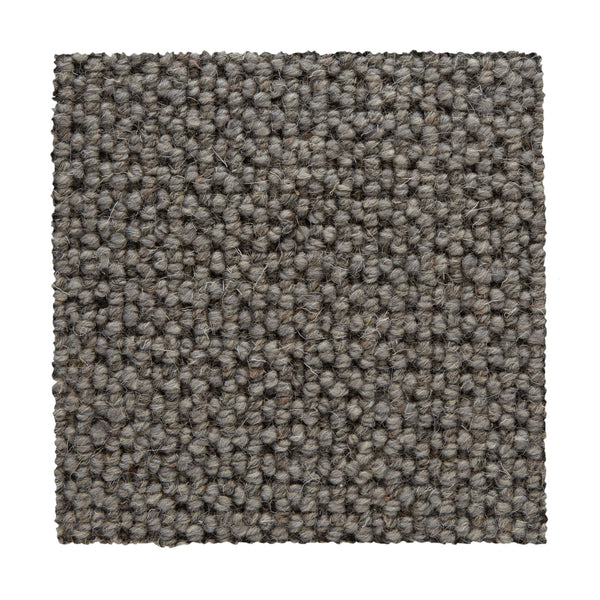 A square swatch of Bellarine Berber Carpet in Gray Matter showcases textured loop-pile fibers in light and dark gray tones on a white base, emphasizing its stylish look and durability as a carpet option.