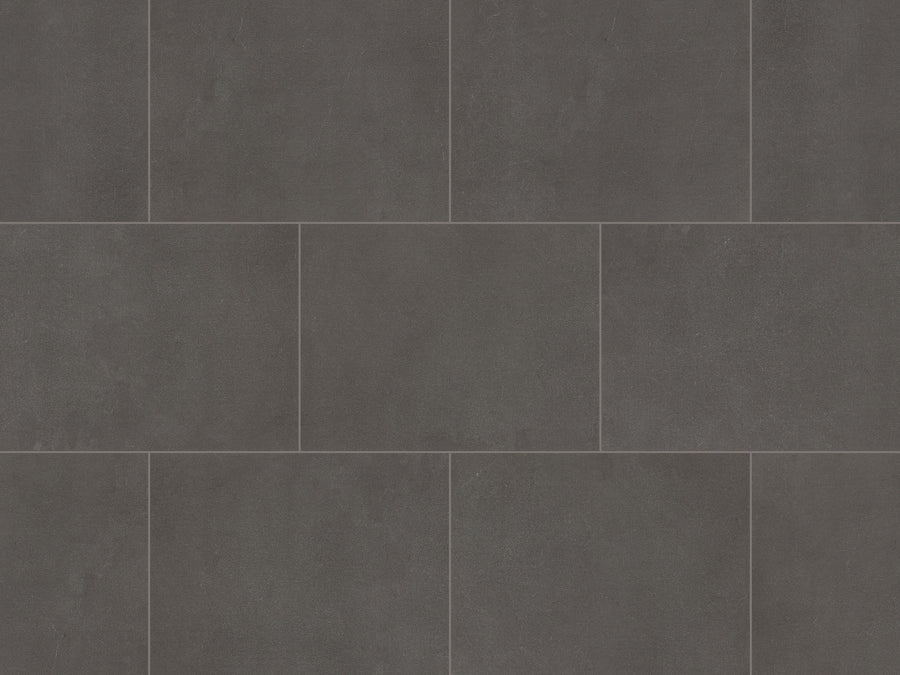 Korlok Select 18" Vinyl Plank in Black Sands features dark gray rectangular tiles with subtle shading and texture variations, arranged in a staggered pattern for a modern look that rivals natural materials.