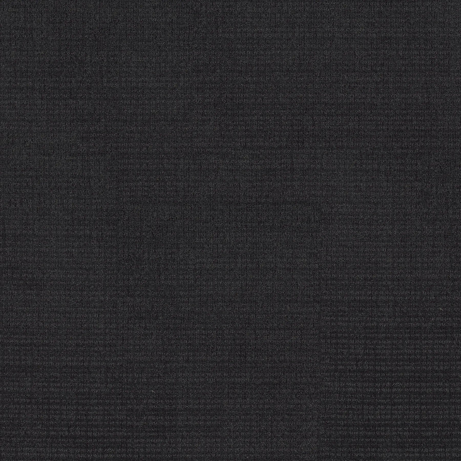 A close-up of Sierra Vista Pet Friendly Carpet in Blackout shows a dark, textured surface with a subtle grid pattern—ideal for adding contemporary style to any space.