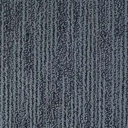 Close-up of Advocate Berber Carpet in Blue Ribbon shows textured fibers with subtle vertical stripes, combining looped and cut styles to add depth and dimension.