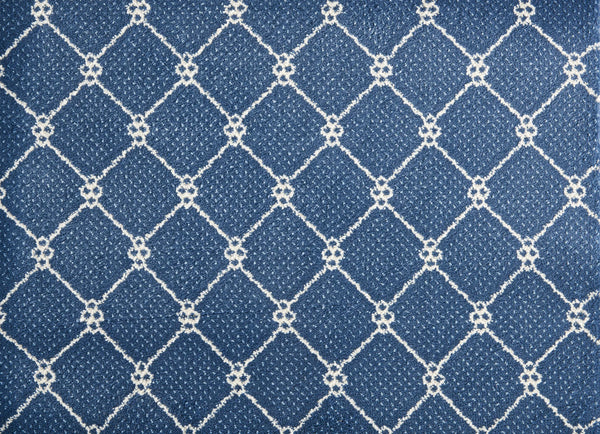 The Lake Boden Berber Carpet in Bluestone features a white diamond grid pattern with small loops at the intersections, offering a stylish and durable option for modern home flooring.