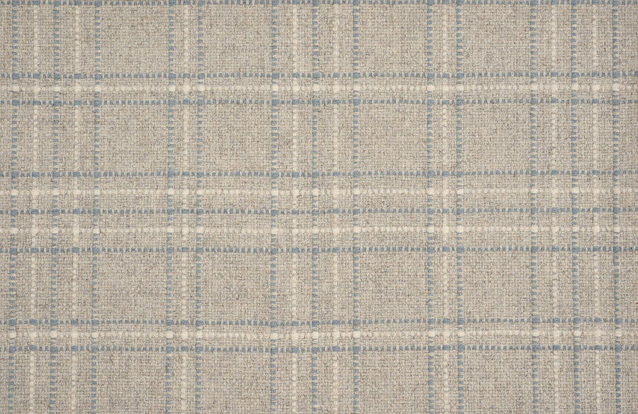 A close-up of Pristine Plaid Berber Carpet in Bluestone, showcasing its textured plaid pattern with intersecting lines—perfect for adding durability and sophistication to any space.
