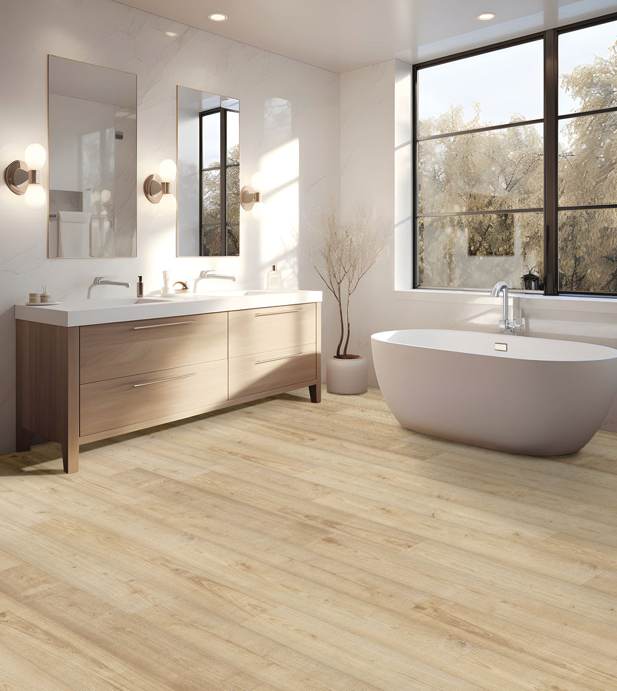 A modern bathroom with light wood floors, a freestanding white bathtub, double vanity with two mirrors, wall sconces, and large windows letting in natural light.