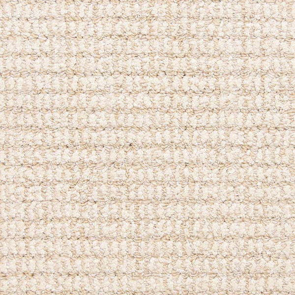 Close-up of Aspen Berber Carpet in Bone color, featuring a soft, tightly woven looped texture. The grid-like pattern highlights the carpet’s durability and uniform, stylish appearance.
