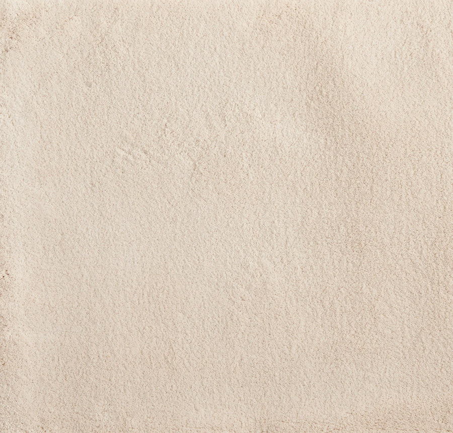 Close-up of the Cha Cha On Trend Carpet in Bone—showing its smooth, light beige texture with subtle shading and faint irregular marks for added visual interest, perfect for elegant, durable flooring in contemporary spaces.