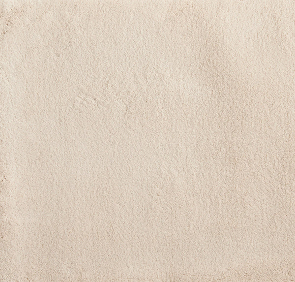 Close-up of the Cha Cha On Trend Carpet in Bone—showing its smooth, light beige texture with subtle shading and faint irregular marks for added visual interest, perfect for elegant, durable flooring in contemporary spaces.