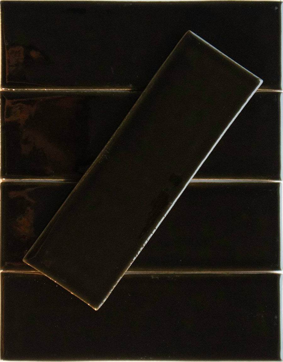 Five Noir Crackle 2.5x8 Ceramic Tiles in Brew-tiful are arranged horizontally, with a sixth tile placed diagonally on top.
