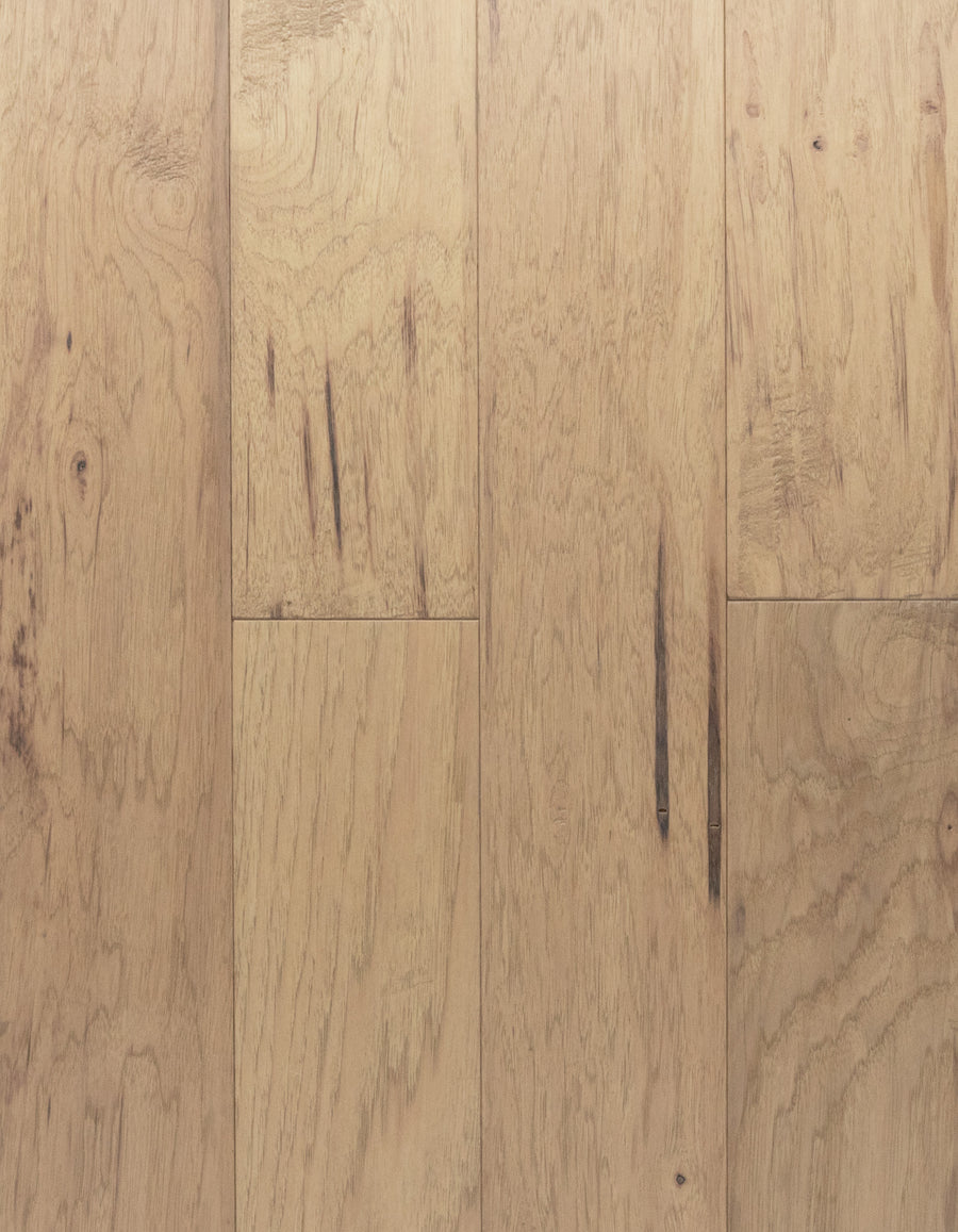 Deepwood Trail 5" Hickory Oak Hardwood in Bridalveil features a light brown hue with natural grain patterns and occasional dark streaks. The engineered hardwood planks are precisely aligned to create a seamless, smooth surface that exudes a warm, rustic charm.