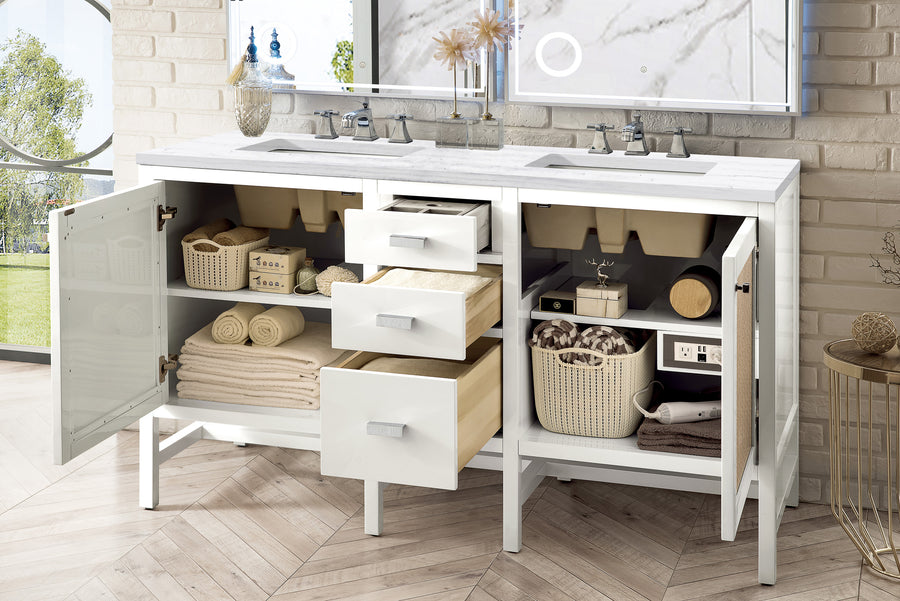 A white double-sink bathroom vanity with open cabinet doors and drawers, neatly organized with towels, baskets, toiletries, and bathroom essentials on shelves and inside drawers. A large mirror is visible above the vanity.