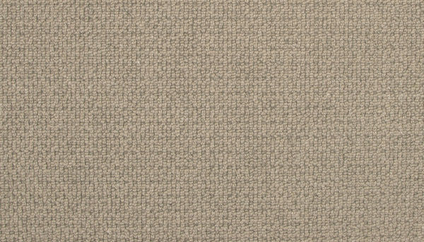 Close-up of Brixham Berber Carpet in Corduroy color—features a soft, tightly woven beige surface with a subtle textured grid pattern, offering durable style ideal for luxury home decor or upholstery projects.
