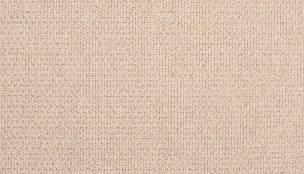 Close-up of the Brixham Berber Carpet in Sandbar, showing a tight, grid-like weave. The beige surface is soft and uniform, with subtle thread color variations for an elegant, luxurious appearance.
