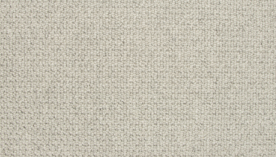 Close-up of Brixham Berber Carpet in Salutation—light beige, tightly woven loops form a uniform, durable surface with a soft, subtly textured feel.