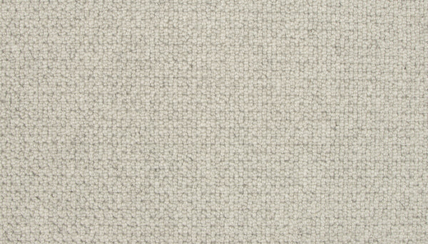Close-up of Brixham Berber Carpet in Salutation—light beige, tightly woven loops form a uniform, durable surface with a soft, subtly textured feel.